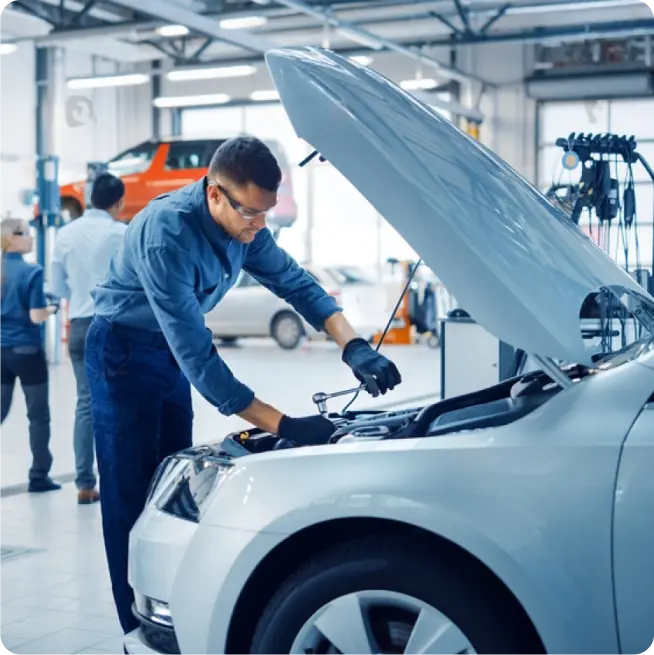 Technician Repairing A Car - Web's Auto
