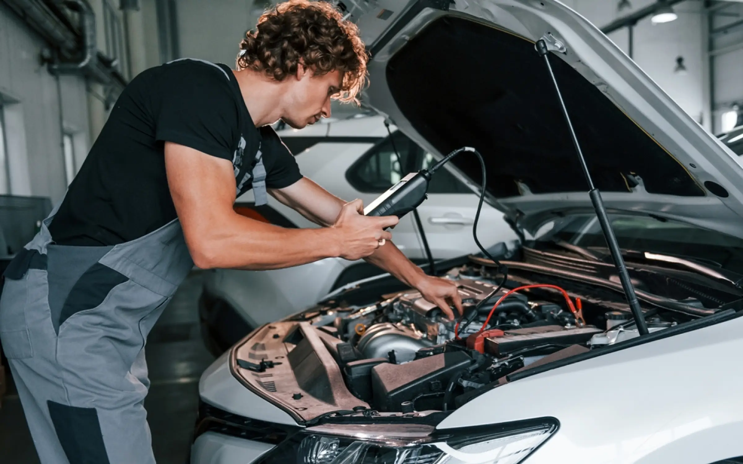Technician Inspecting Car - Web's Auto